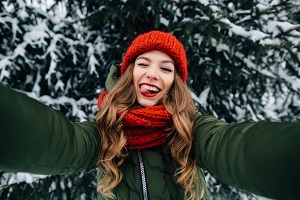 Woman Taking a Selfie with Winter Background 
